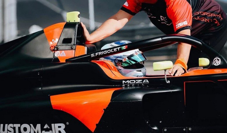 DXR driver in the cockpit with a race engineer preparing the car