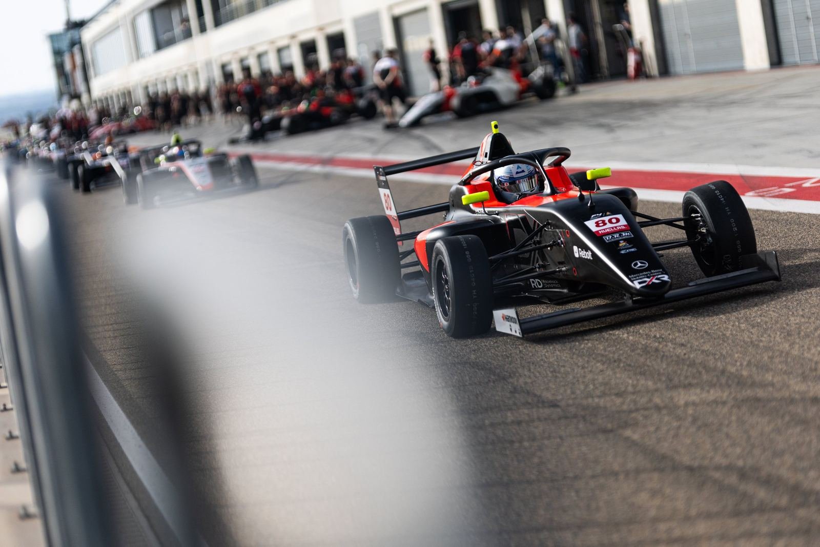 DX Racing Team single-seater exiting the pit lane, 2026